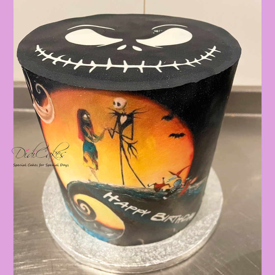 A round cake with a The Nightmare Before Christmas theme, decorated with characters from the movie and a 'Happy Birthday' message.
